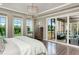 A primary bedroom with a covered deck, hardwood floors, seating, and decorative draperies at 318 Ivy Ridge Rd, Chapel Hill, NC 27516