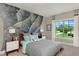 Unique bedroom features a climbing wall mural, complemented by natural light from a window and coordinated decor at 318 Ivy Ridge Rd, Chapel Hill, NC 27516