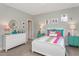 Inviting bedroom features a colorful bed, complemented by twin teal nightstands and a decorative white mirror at 318 Ivy Ridge Rd, Chapel Hill, NC 27516