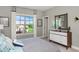 Bright bedroom with a large window offering scenic views and a stylish mid-century modern dresser with mirror at 318 Ivy Ridge Rd, Chapel Hill, NC 27516