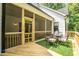 Exterior of deck with a view into the screened in porch with an outdoor dining set at 318 Ivy Ridge Rd, Chapel Hill, NC 27516