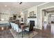 Elegant dining room featuring hardwood floors, a modern light fixture, and a fireplace with a white brick surround at 318 Ivy Ridge Rd, Chapel Hill, NC 27516