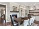 Elegant dining room with a stone fireplace, built-in shelving, and a modern chandelier at 318 Ivy Ridge Rd, Chapel Hill, NC 27516