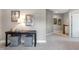 A carpeted hallway with decoratively adorned table, lamps, artwork, and a neutral color palette at 318 Ivy Ridge Rd, Chapel Hill, NC 27516