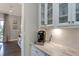 Kitchenette features white cabinets, marble countertops, and a Keurig coffee machine at 318 Ivy Ridge Rd, Chapel Hill, NC 27516