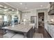 Spacious kitchen with a large island and stainless steel appliances opens to other rooms in the home at 318 Ivy Ridge Rd, Chapel Hill, NC 27516
