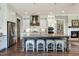 Bright, airy kitchen featuring a large island with seating, white cabinetry, and stainless steel appliances at 318 Ivy Ridge Rd, Chapel Hill, NC 27516