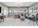 A recreational living room with comfortable seating, a modern light fixture, and large windows at 318 Ivy Ridge Rd, Chapel Hill, NC 27516