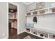 Well-organized mudroom with custom built-in storage, bench seating, and decorative accents at 318 Ivy Ridge Rd, Chapel Hill, NC 27516