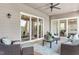 Spacious outdoor patio with comfortable seating, ceiling fan, and views of the backyard at 318 Ivy Ridge Rd, Chapel Hill, NC 27516