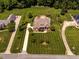 Expansive aerial view of property showcasing the manicured lawn and pool at 3403 Raccoon Run Dr, Burlington, NC 27215