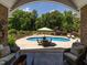 Beautiful backyard with a pool, landscaping, and an umbrella-covered table at 3403 Raccoon Run Dr, Burlington, NC 27215