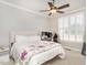 Bright bedroom featuring a bed, ceiling fan, and shutters at 3403 Raccoon Run Dr, Burlington, NC 27215