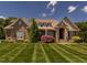 Beautiful brick home with manicured lawn, mature landscaping, and inviting curb appeal at 3403 Raccoon Run Dr, Burlington, NC 27215