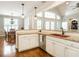 Kitchen featuring white cabinets, granite countertops, stainless steel appliances, and a breakfast area at 3403 Raccoon Run Dr, Burlington, NC 27215