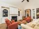 Warm living room with a fireplace, built-in bookshelves, and views into the dining and kitchen areas at 3403 Raccoon Run Dr, Burlington, NC 27215