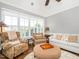 Living room featuring high ceilings, hardwood floors, fireplace, and several chairs with patterned fabrics at 3403 Raccoon Run Dr, Burlington, NC 27215