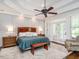 Main bedroom featuring a large bed, sitting area, a ceiling fan, and lots of natural light at 3403 Raccoon Run Dr, Burlington, NC 27215