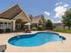 Stunning backyard pool and patio with beautiful home exterior at 3403 Raccoon Run Dr, Burlington, NC 27215