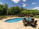 Inviting pool area with outdoor seating and lush landscaping at 3403 Raccoon Run Dr, Burlington, NC 27215