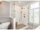 Stylish walk-in shower with white subway tile and a pebble floor at 3403 Raccoon Run Dr, Burlington, NC 27215