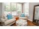 Sitting area featuring hardwood floors, neutral armchairs, an ottoman, and lots of natural light at 3403 Raccoon Run Dr, Burlington, NC 27215