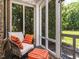 Cozy sunroom with comfortable seating and views of the landscaped backyard at 3403 Raccoon Run Dr, Burlington, NC 27215