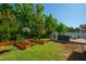 Backyard features custom grill, outdoor kitchen, and raised garden beds with trellises at 3678 Horton Hill Dr, New Hill, NC 27562
