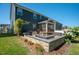 Inviting backyard patio area with outdoor seating, perfect for entertaining with fire pit, porch and lush landscaping at 3678 Horton Hill Dr, New Hill, NC 27562