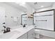 Bathroom with double vanity, white cabinets, large mirror, and tiled shower with glass doors at 3678 Horton Hill Dr, New Hill, NC 27562