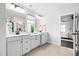White bathroom features double sinks, white countertops, and modern fixtures at 3678 Horton Hill Dr, New Hill, NC 27562