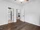 A bedroom featuring hardwood floors with views of the en suite bath and kitchen at 3678 Horton Hill Dr, New Hill, NC 27562