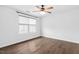Neutral bedroom with hardwood floors, ceiling fan, window with blind, and base molding at 3678 Horton Hill Dr, New Hill, NC 27562