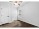A bright bedroom with hardwood floors, a ceiling fan, a window, and a door at 3678 Horton Hill Dr, New Hill, NC 27562