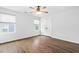 Bedroom with hardwood floors, ceiling fan, two windows with blinds, and white closet doors at 3678 Horton Hill Dr, New Hill, NC 27562