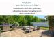Outdoor living space featuring a built-in firepit, paver patio, and lush landscaping at 3678 Horton Hill Dr, New Hill, NC 27562