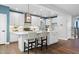 Modern kitchen with an island, stylish pendant lights, and stainless steel appliances at 3678 Horton Hill Dr, New Hill, NC 27562