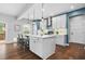 Modern kitchen featuring white cabinets, hardwood floors, stainless steel appliances, and island at 3678 Horton Hill Dr, New Hill, NC 27562