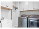 Well-organized laundry room equipped with modern washer, dryer, and ample storage at 3678 Horton Hill Dr, New Hill, NC 27562