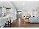 Spacious open floor plan with hardwood floors seamlessly connecting the living room, kitchen, and entryway at 3678 Horton Hill Dr, New Hill, NC 27562