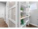 A walk-in pantry featuring custom shelving, drawers, a sliding glass door, and natural lighting at 3678 Horton Hill Dr, New Hill, NC 27562