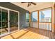 Screened porch with wood floors and ceiling fan, with view of backyard at 3678 Horton Hill Dr, New Hill, NC 27562