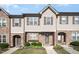 Charming townhome featuring a stone and siding facade, complemented by manicured landscaping and inviting entrances at 3945 Amelia Park Dr, Raleigh, NC 27606