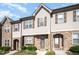 Attractive townhome showcasing a blend of stone and siding, accented by well-maintained front yard landscaping at 3945 Amelia Park Dr, Raleigh, NC 27606
