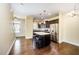 Well-appointed kitchen featuring a granite island, stainless steel appliances, and dark wood cabinetry at 3945 Amelia Park Dr, Raleigh, NC 27606