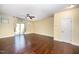Bright living room boasts hardwood floors, a ceiling fan, and sliding glass doors leading to the backyard at 3945 Amelia Park Dr, Raleigh, NC 27606