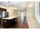 A spacious living room features wood floors and an island with stool seating near a modern stainless steel refrigerator at 3945 Amelia Park Dr, Raleigh, NC 27606