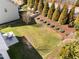 Well-maintained backyard featuring a lush lawn, patio area, mature trees, and landscape beds at 4 Seawell Ct, Durham, NC 27703