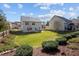 Expansive backyard boasts a well-kept lawn, mature trees, privacy fence, and outdoor seating area at 4 Seawell Ct, Durham, NC 27703
