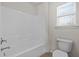 Bathroom showcasing a white shower-tub combination and a toilet at 4 Seawell Ct, Durham, NC 27703